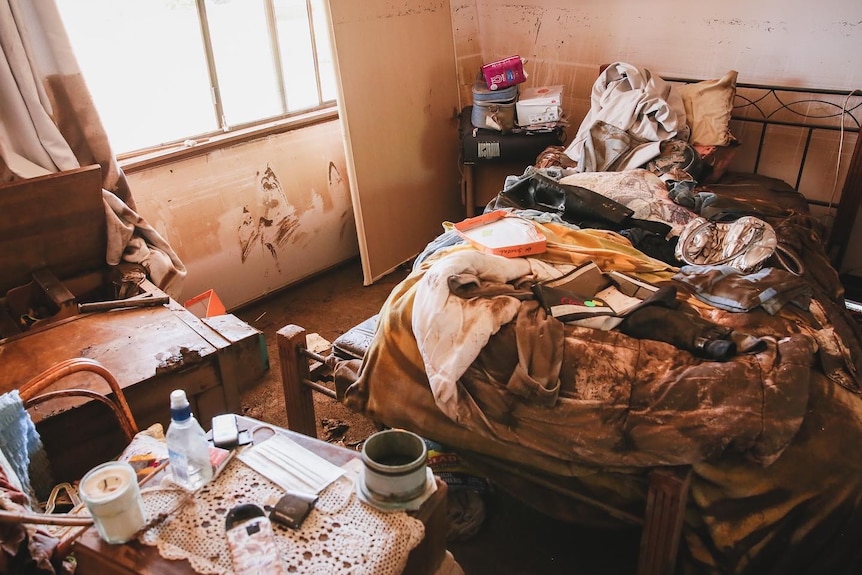 Bedroom littered with flood spoiled clothes