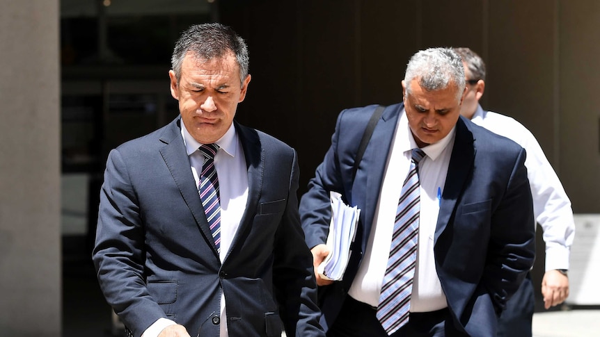 Lawyers Alex Nelson (left) and Sam Iskander, acting for Clive Mensink, leave the Federal Court in Brisbane.