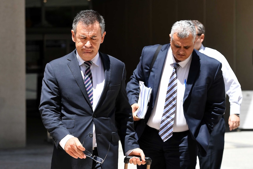 Lawyers Alex Nelson (left) and Sam Iskander, acting for Clive Mensink, leave the Federal Court in Brisbane.