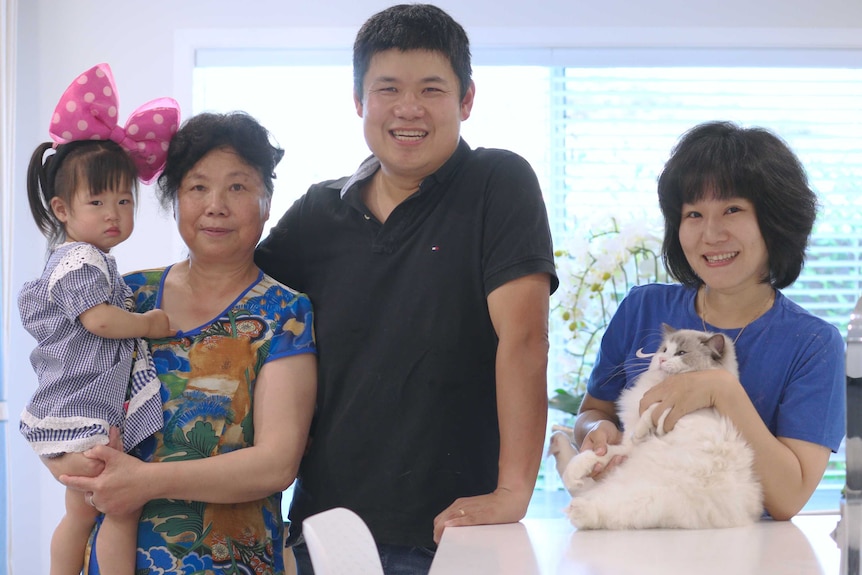 Xu family standing in the kitchen