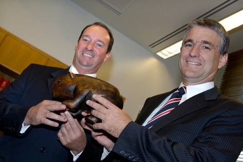 John Anderson (right) presents the carved wooden Wombat to his successor as federal party leader, Mark Vaile,  23 June 2005.