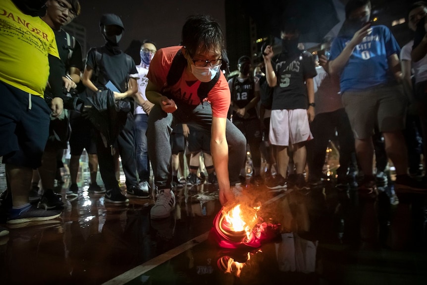 Protesters set a jersey of LeBron James on fire in the street.