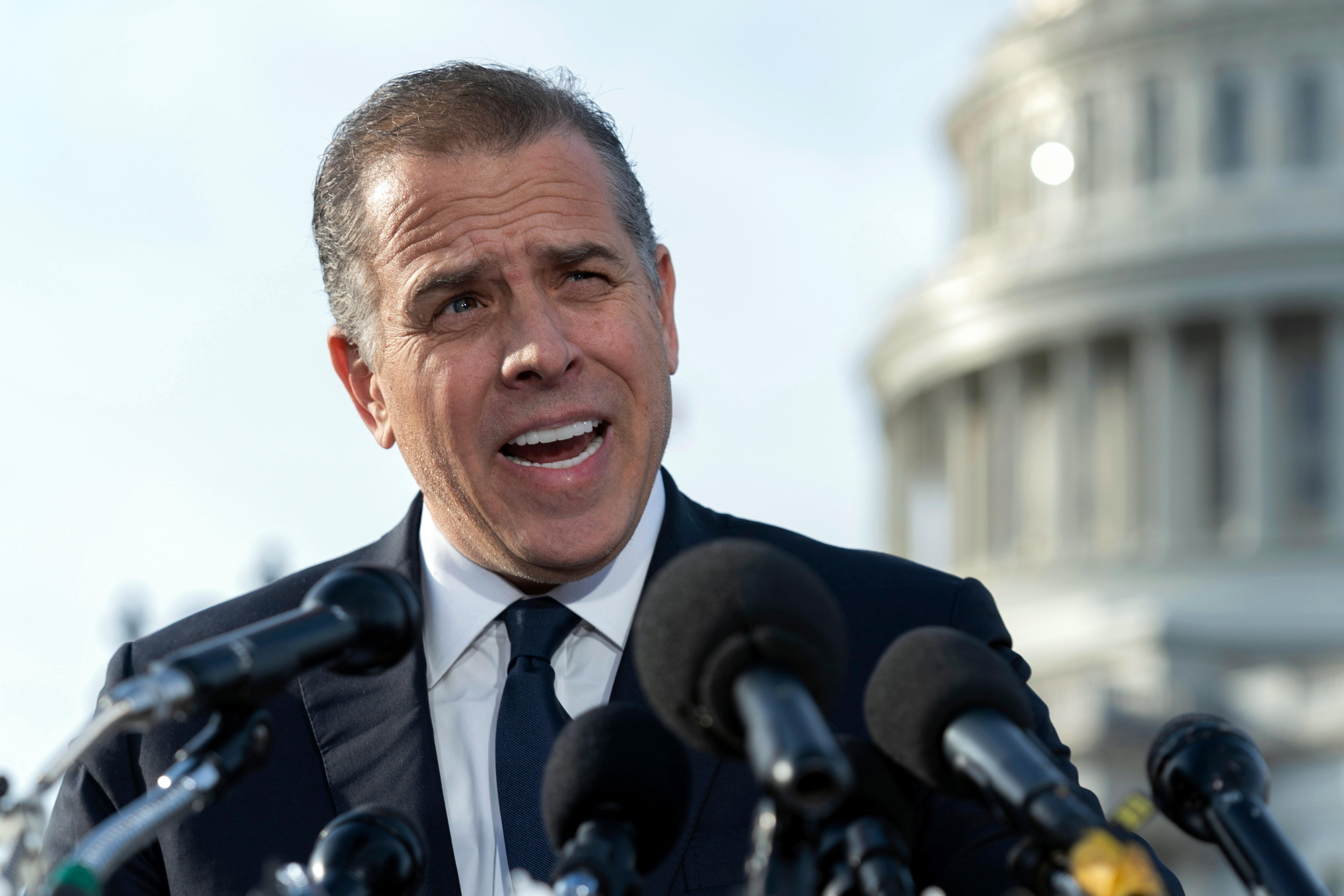 Hunter Biden in a suit speaks outside the US Capitol