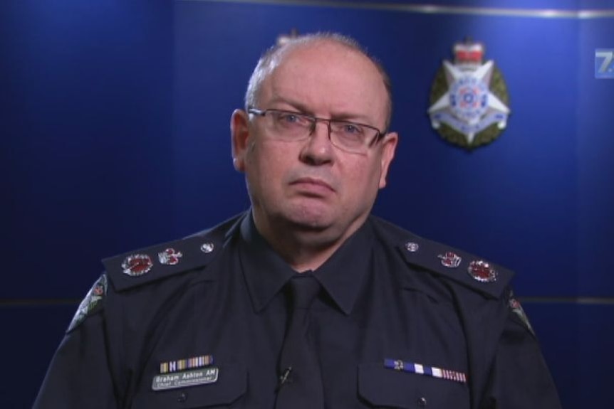 Victoria Police Chief Commission Graham Ashton wearing a police uniform, glasses and looking into the camera.