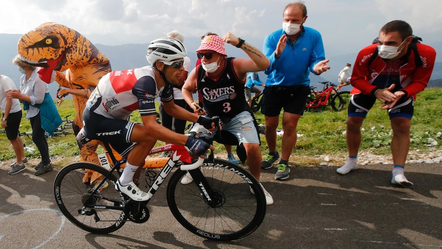 Fans scream at Richie Porte as he climbs a mountain on his bike during the Tour de France.