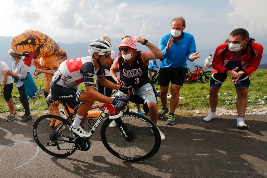 Fans scream at Richie Porte as he climbs a mountain on his bike during the Tour de France.
