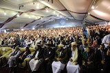 Landmark conference: Delegates look on as Afghan president Hamid Karzai delivers a speech to the jirga