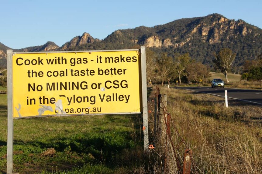 A sign alongside a country road says 'cook with gas — it makes the coal taste better. No Mining or CSG in the Bylong valley'
