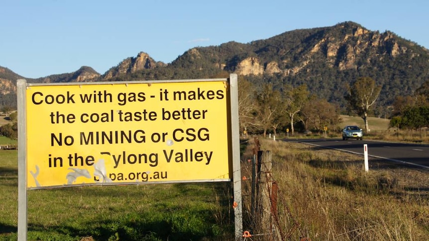 A sign alongside a country road says 'cook with gas — it makes the coal taste better. No Mining or CSG in the Bylong valley'