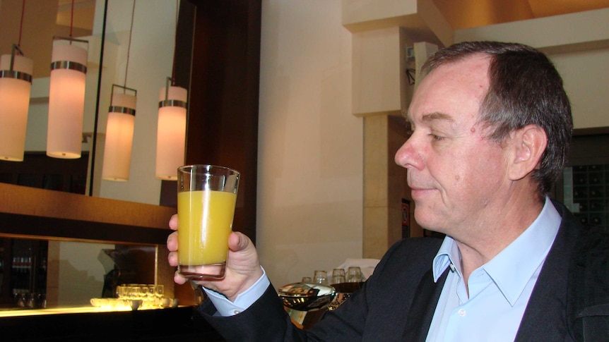 CSIRO nutrition researcher Dr Malcolm Riley holds a glass of orange juice at a Sydney hotel