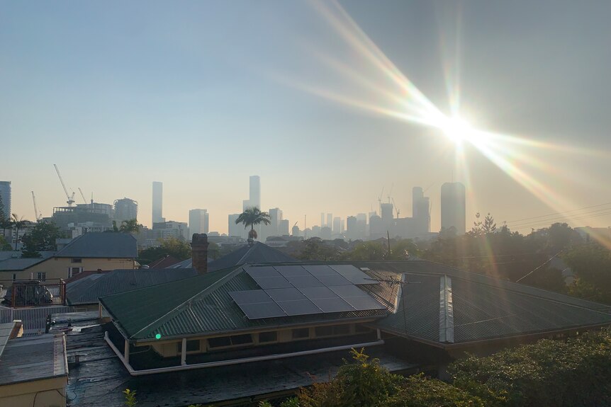Smoke haze fills sky over Brisbane from Highgate Hill, lines coming from around the sun