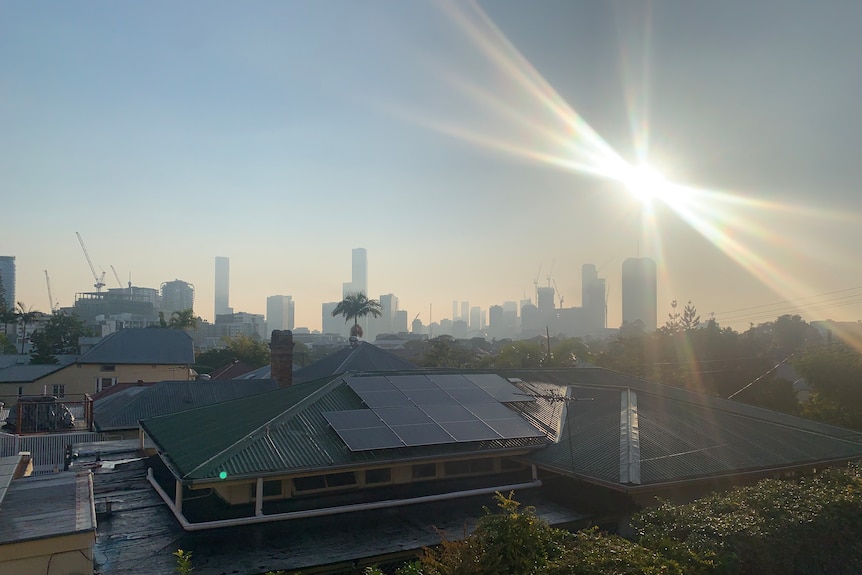 Smoke haze fills sky over Brisbane from Highgate Hill, lines coming from around the sun