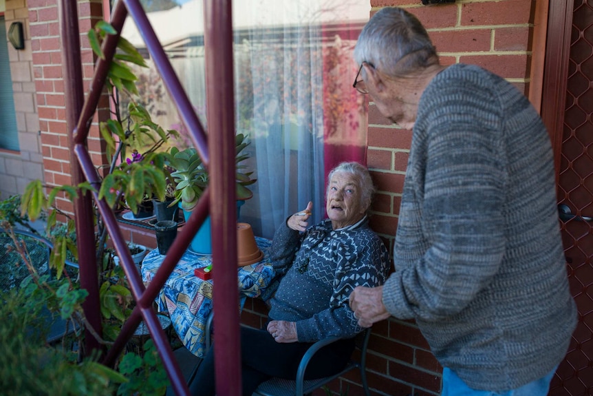 Bev Howlett talking to partner Bob outside her hostel unit at Wintringham.