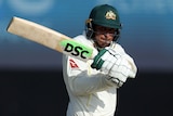 An Australian Test male batter players a shot to the leg side against Sri Lanka.
