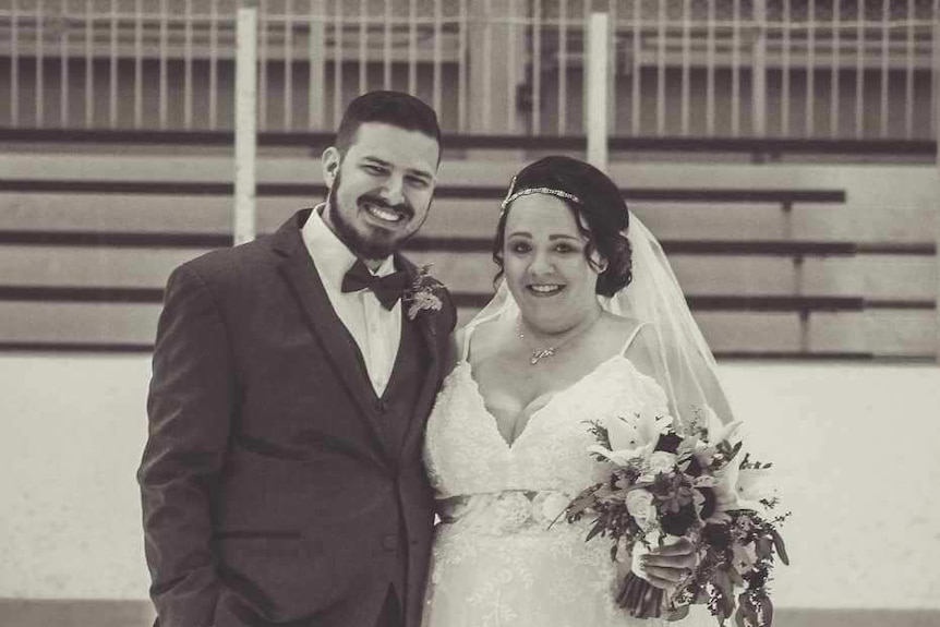 A black and white photo of a groom and a brideon their wedding day 