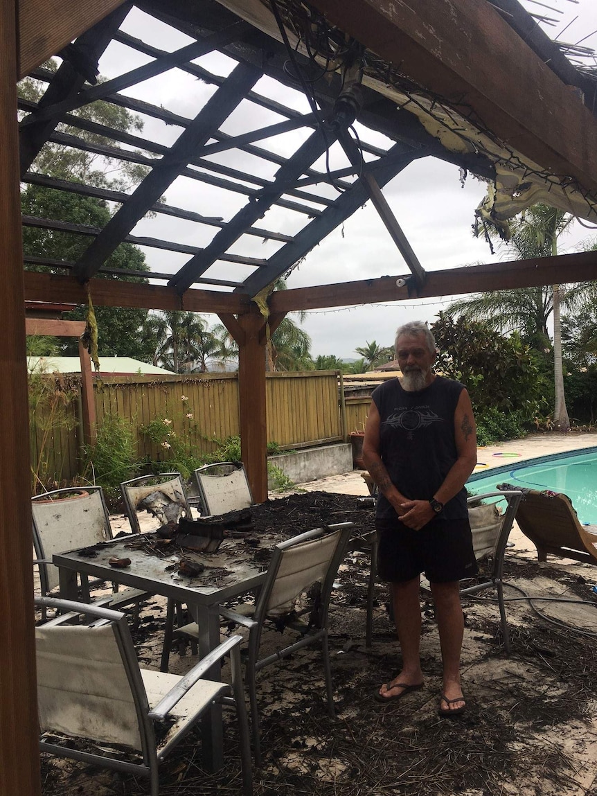Peter Smider stands next to his destroyed gazebo.