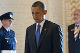 Barack Obama pauses during a moment of silence after laying a wreath at the Australian War Memorial.