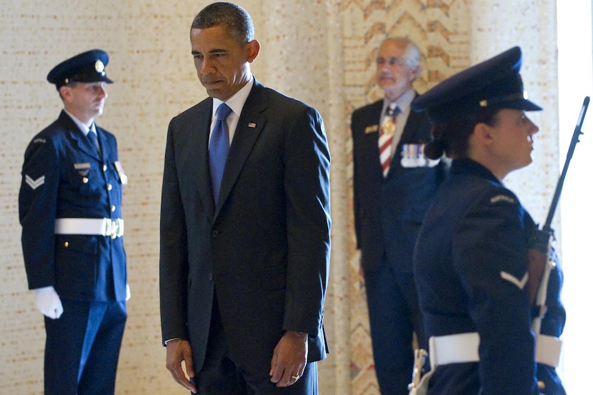 Barack Obama pauses during a moment of silence after laying a wreath at the Australian War Memorial.