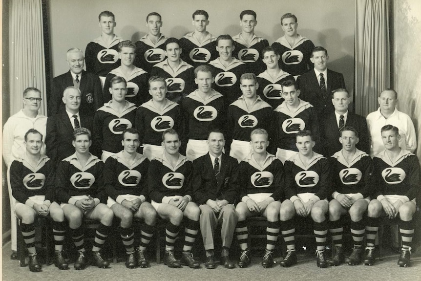 A black and white photo of a mens AFL team.