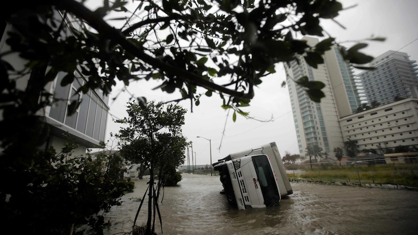 A truck is seen turned over in Miami.