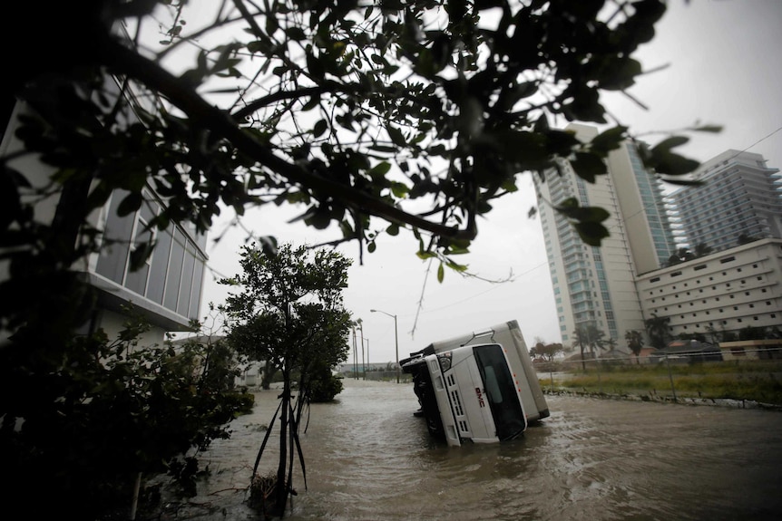 A truck is seen turned over in Miami.