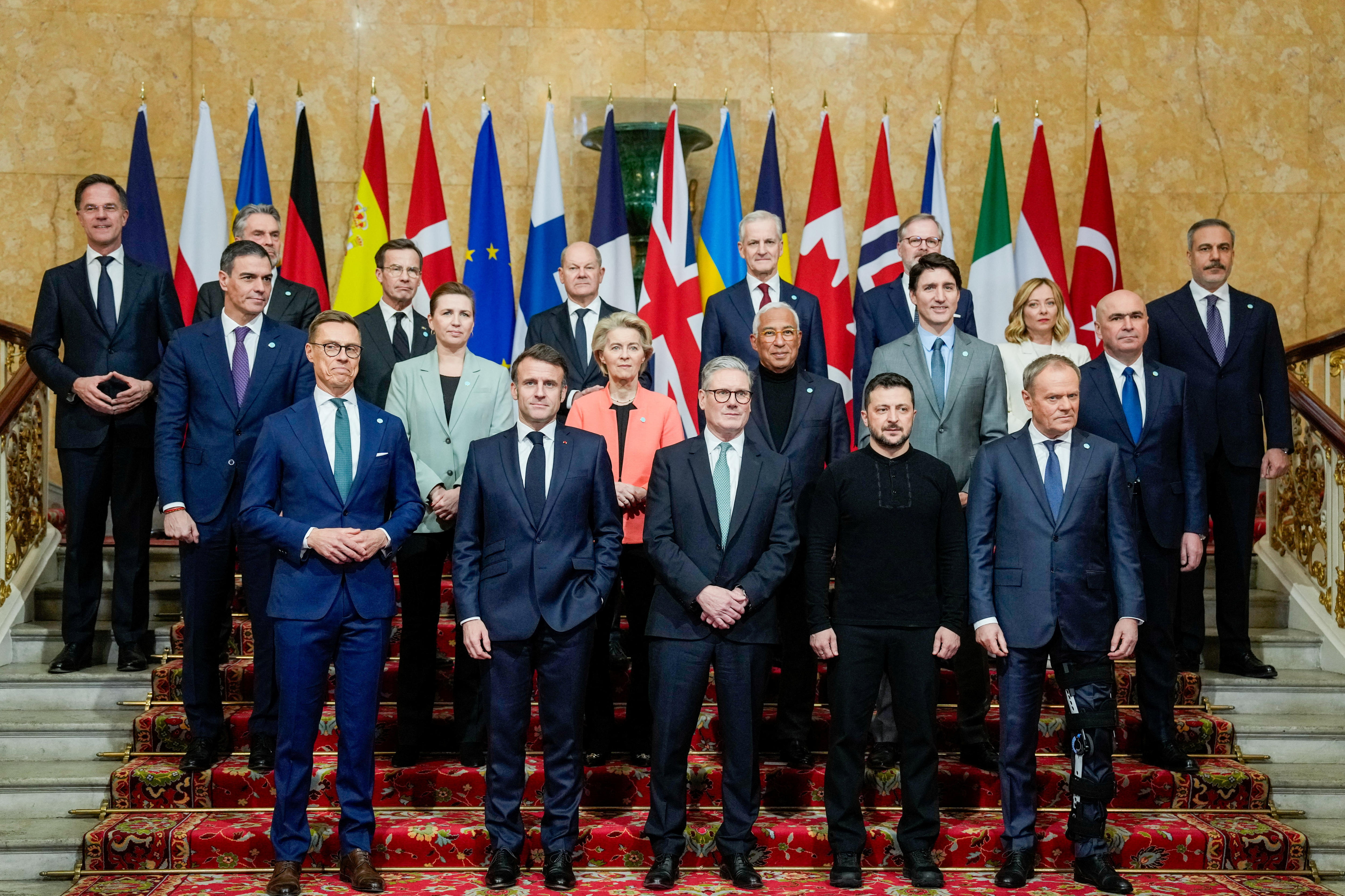 A group photo of over a dozen European leaders standing on the steps of Lancaster House.