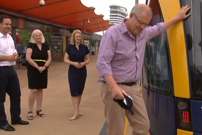 Scott Morrison alongside three other politicians and a tram on the Gold Coast