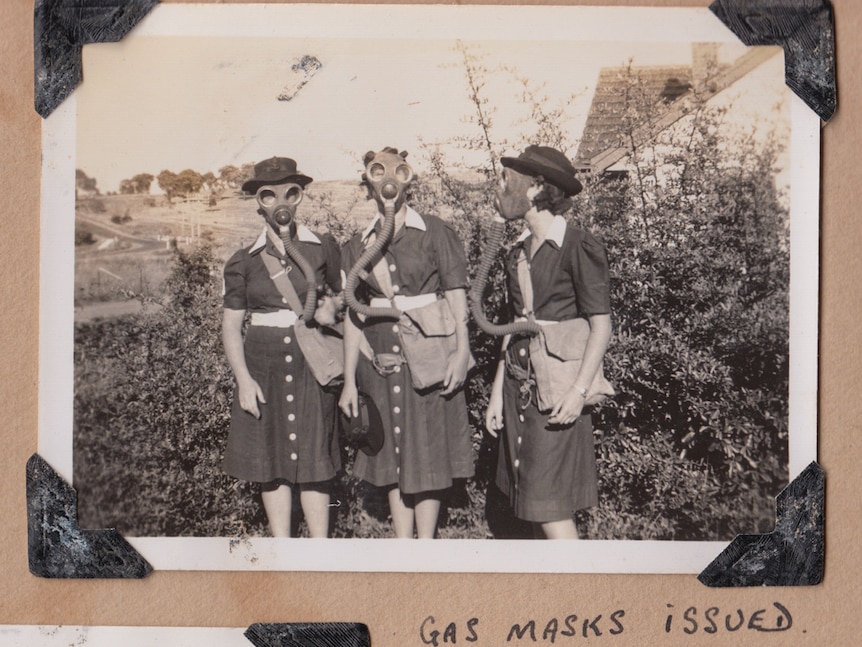 Three Women's Royal Australian Naval Service personnel wearing gas masks.