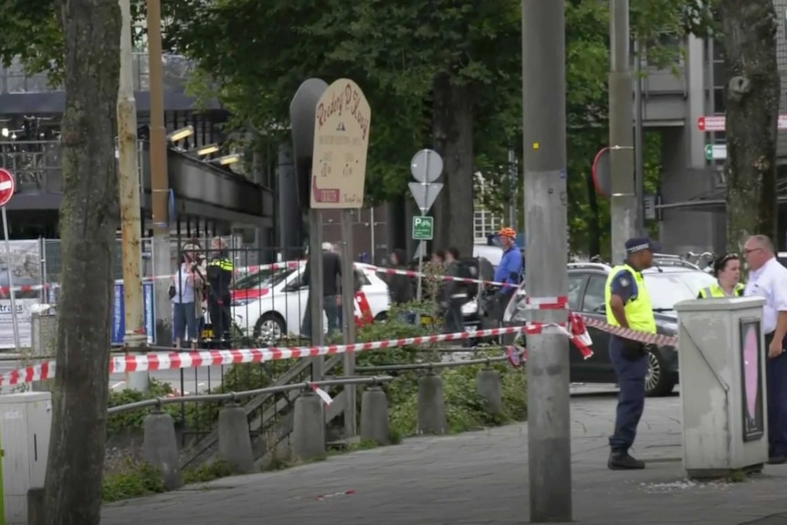 Dutch police officers stand near the scene of a stabbing attack