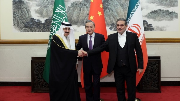 Officials from Iran, Saudi Arabia and China pose for a photo