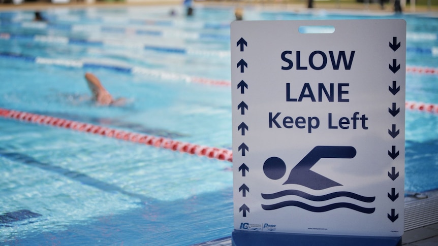 Slow lane sign with swimmer in pool at Gold Coast Aquatic Centre.