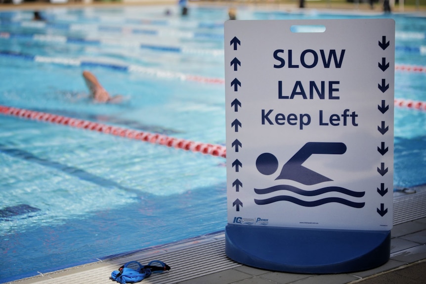 Slow lane sign with swimmer in pool at Gold Coast Aquatic Centre.