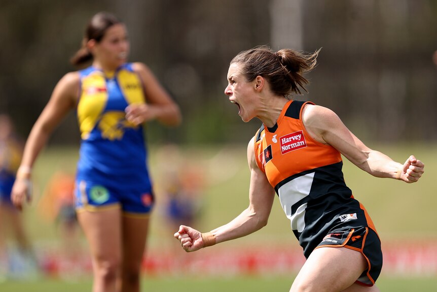 A Giants AFLW player celebrates a goal against the Eagles.