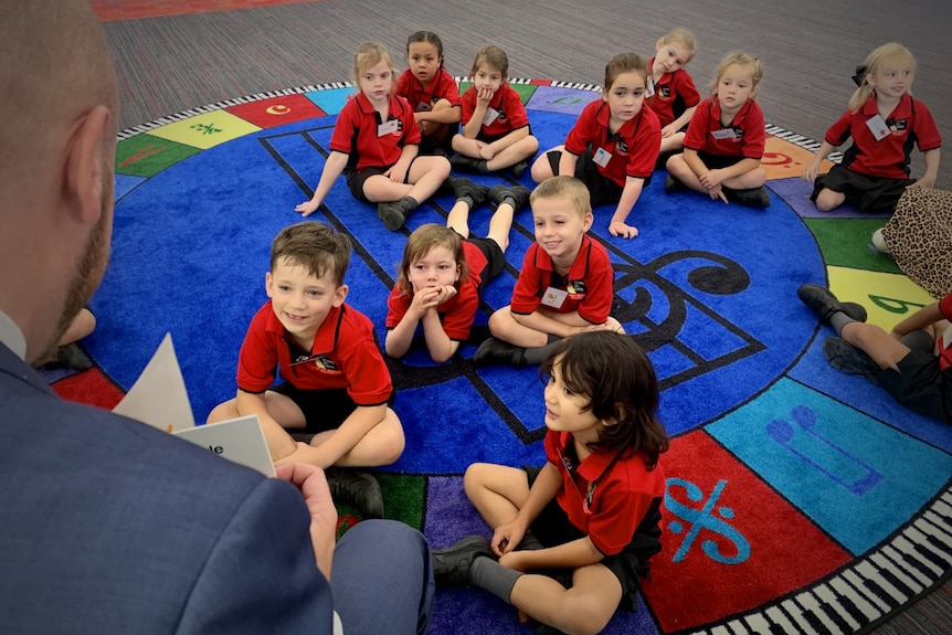 Photo of students being read to at school.