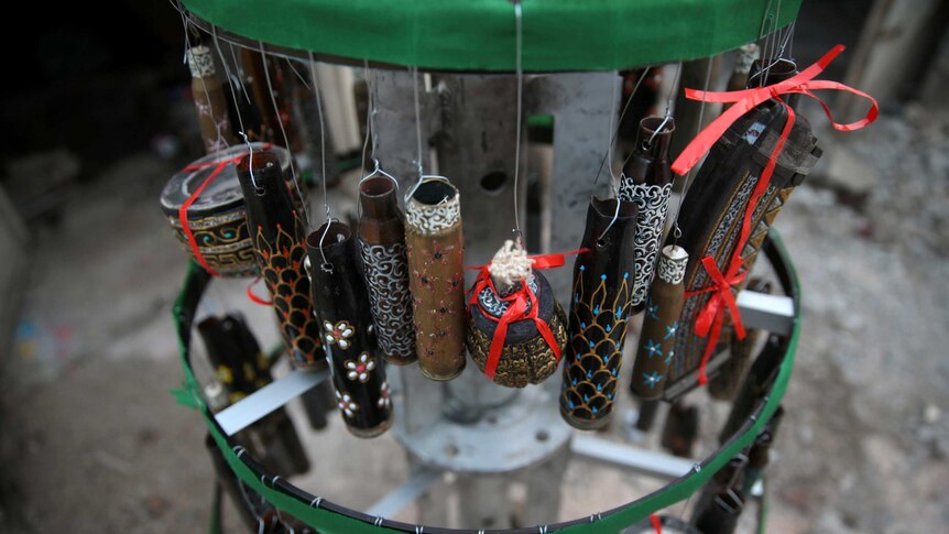 Empty shells hang from a Christmas tree in the rebel held besieged city of Douma in east Damascus.