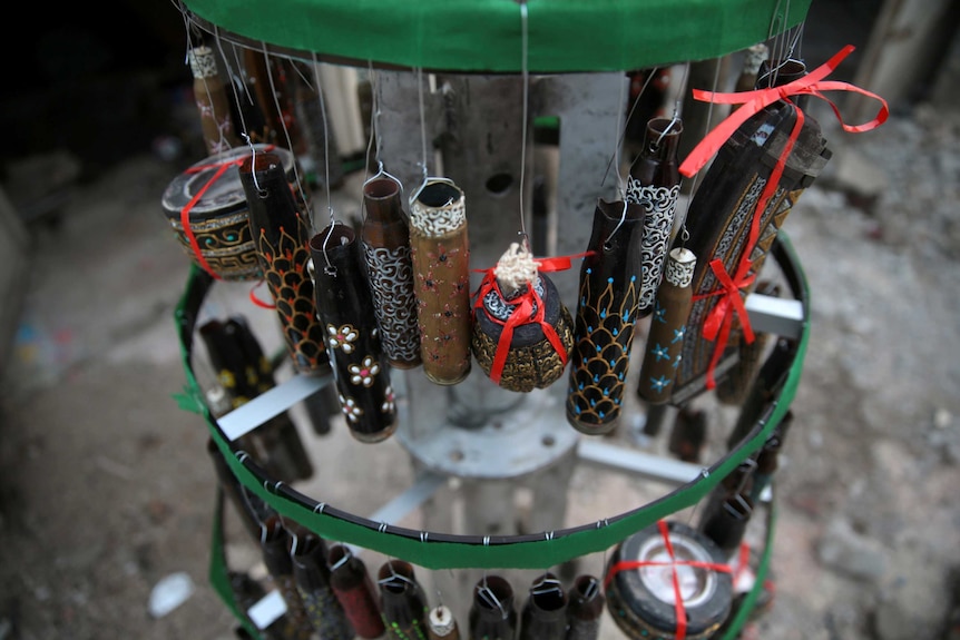 Empty shells hang from a Christmas tree in the rebel held besieged city of Douma in east Damascus.