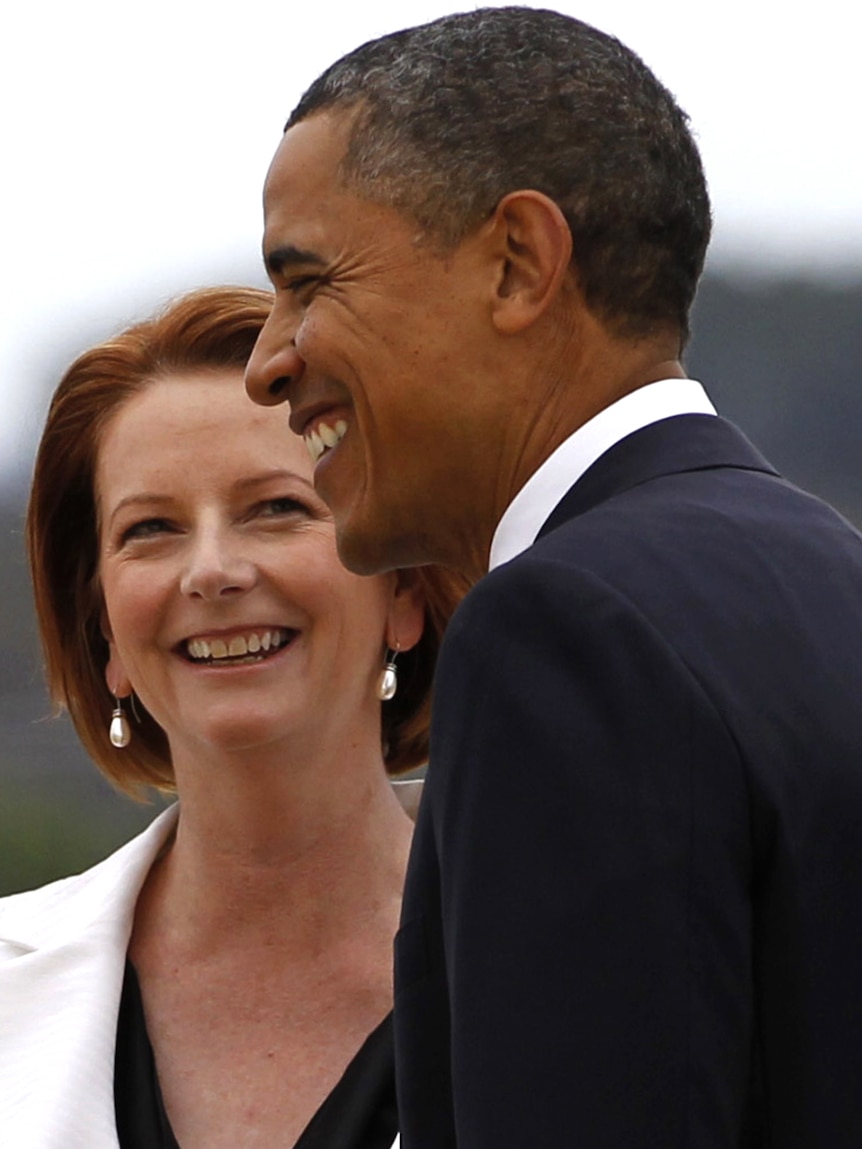 US president Barack Obama is welcomed by Australia's Prime Minister Julia Gillard upon his arrival in Canberra