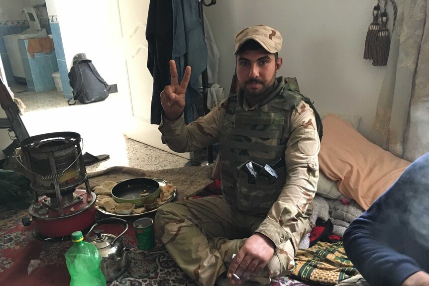 An Iraqi soldier has breakfast before heading for battle.