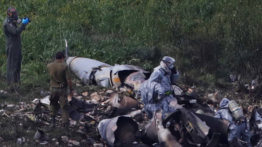 Israeli security forces examine the remains of the F-16 Israeli warplane.