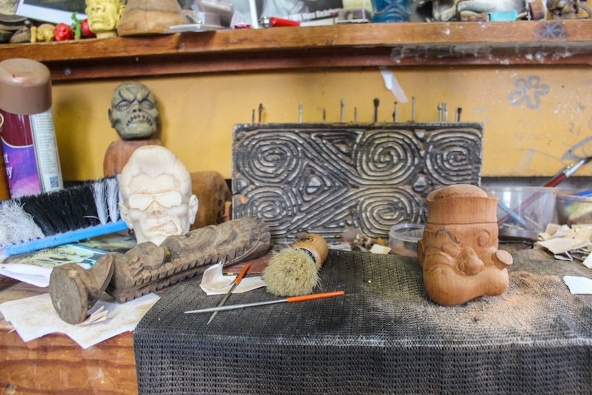 Tools are littered throughout Mr Thorn's work bench including brushes to sweep the wood dust off the carvings.