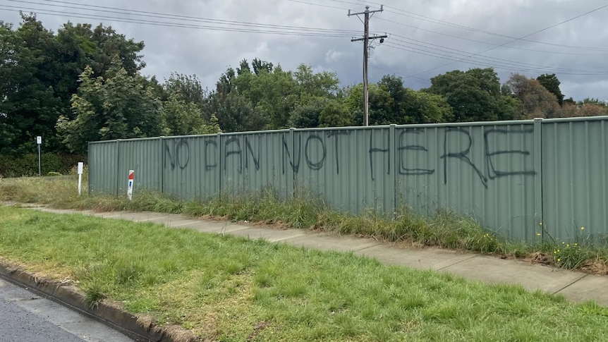 Big writing on a fence reads "NO DAN NOT HERE".