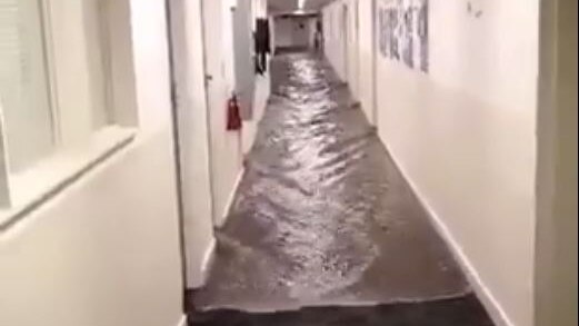 Water comes down a hallway in UTAS's Engineering Faculty, Sandy Bay, Hobart.