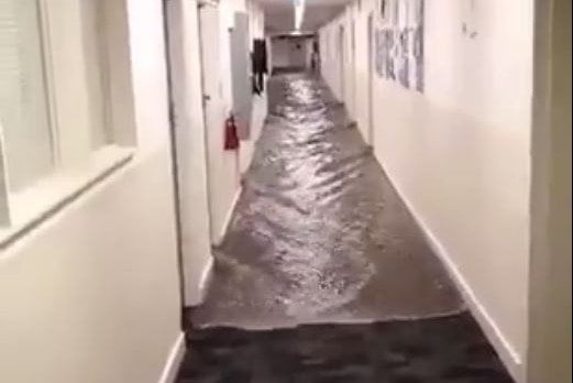 Water comes down a hallway in UTAS's Engineering Faculty, Sandy Bay, Hobart.