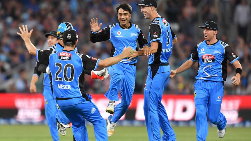 Rashid Khan and the Adelaide Strikers celebrate the wicket of Brisbane's Chris Lynn