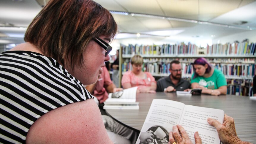 Amelia getting some help from a volunteer at the Next Chapter Book Club at the library in Echuca.