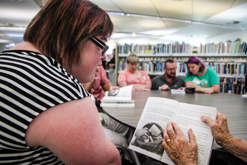 Amelia getting some help from a volunteer at the Next Chapter Book Club at the library in Echuca.