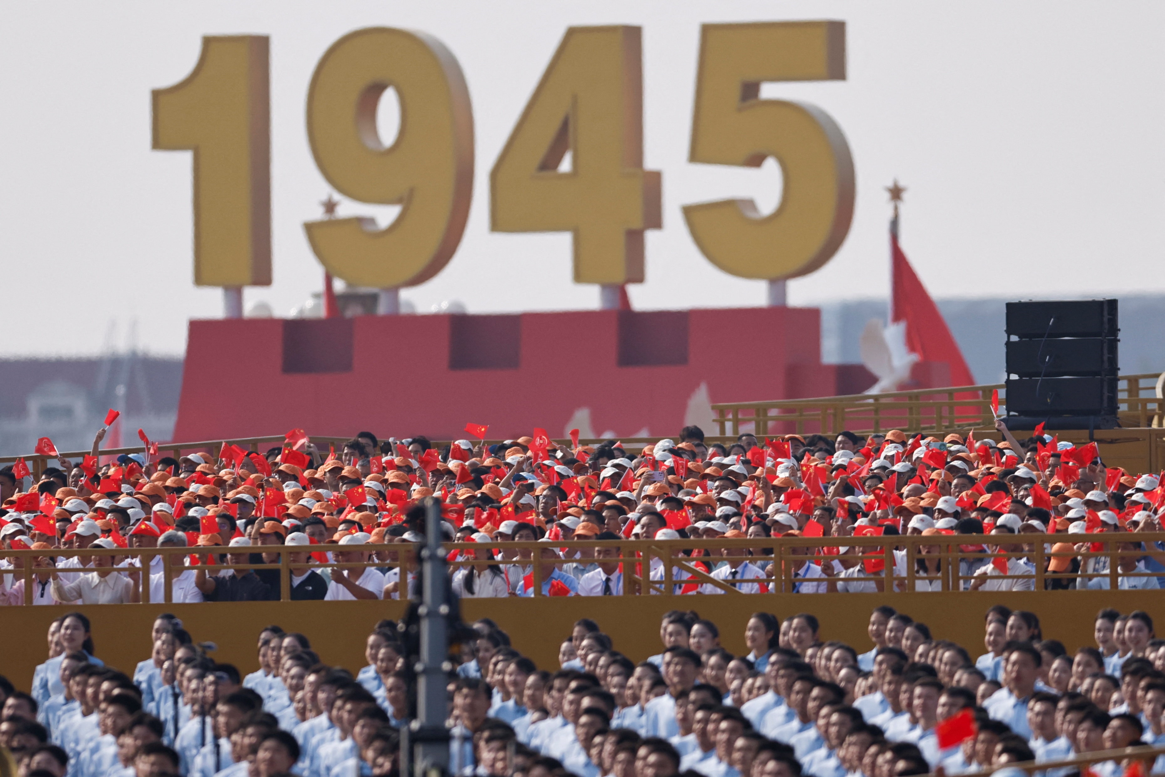 A crowd stands in front of a big 1946 sign