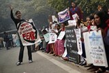 Protesters carry placards as they shout slogans during a protest to mark the first anniversary of the Delhi gang rape.