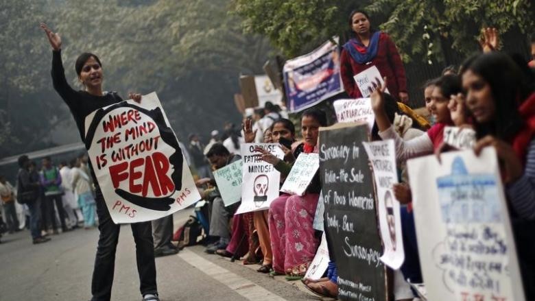 Protesters carry placards as they shout slogans during a protest to mark the first anniversary of the Delhi gang rape.