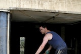 Sweeping and hosing: Peter Carey helps clean a home in Sherwood